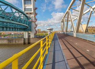 Cycle path on the Algera Bridge over the Hollandse IJssel river. The bridge connects Capelle aan den IJssel and Krimpen aan den IJssel. The blue strip is for walkers. On the left is the storm barrier.