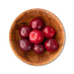 Plums in a bowl isoalted over white background