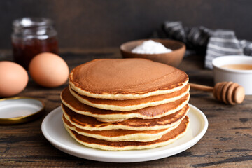 Blini or pancakes stack on wooden table with butter.  Maslenitsa holiday concept. Rustic style...