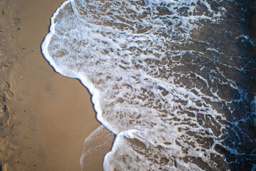 the waves of the sea wash up on a beach