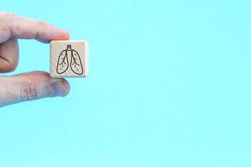 hand keep wooden cube with symbol lung.