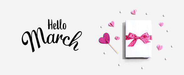 Fototapeta na wymiar Hello March message with a gift box and paper hearts