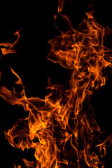 Orange red Fire flame against black background, abstract texture