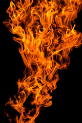 Bright orange yellow red Fire flame against black background, abstract texture
