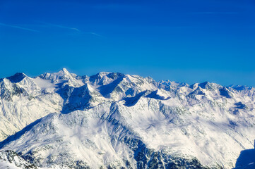Austrian Alps covered with snow during sunny winter day.