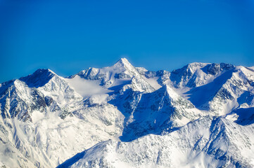 Fototapeta na wymiar Austrian Alps covered with snow during sunny winter day.
