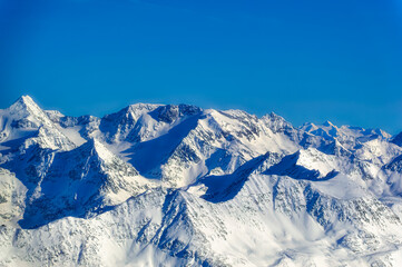 Obraz premium Austrian Alps covered with snow during sunny winter day.