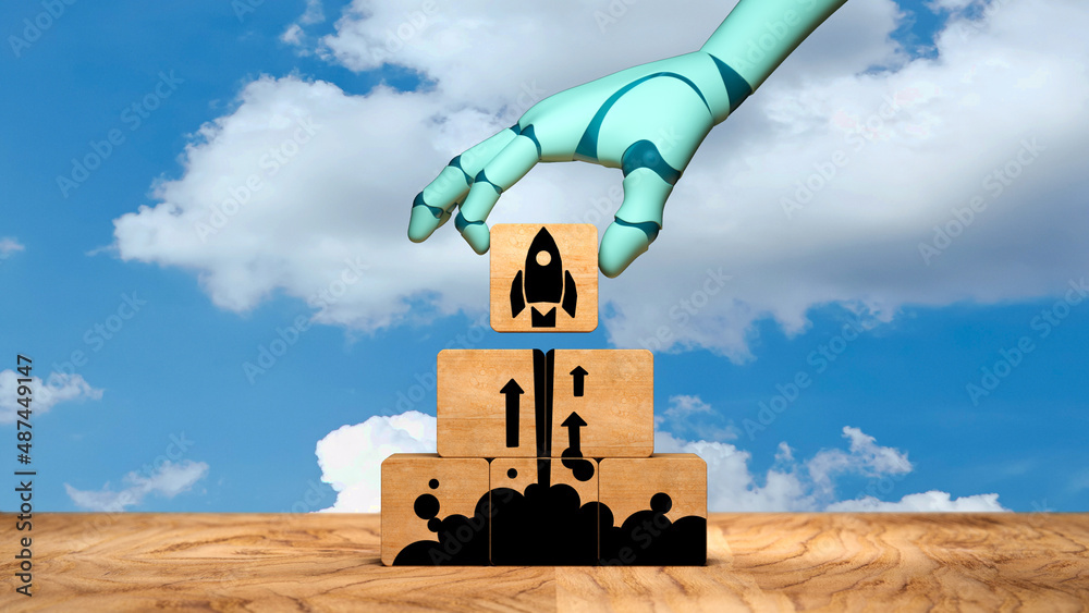 Wall mural robot arm moving a cube with a rocket symbol, symbolizing a liftoff on wooden background