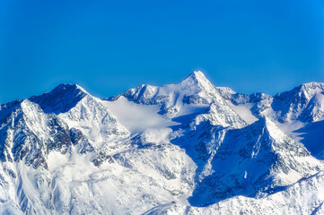 Obraz premium Austrian Alps covered with snow during sunny winter day.