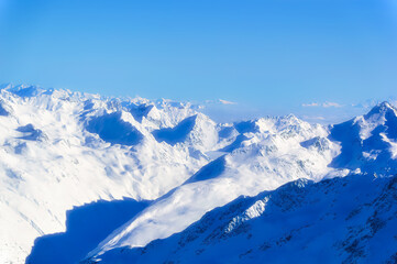 Obraz premium Austrian Alps covered with snow during sunny winter day.