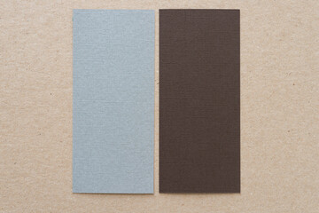two blank paper rectangles on cardboard