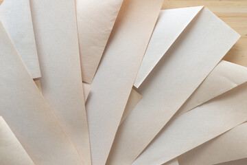 faded pad paper folded into geometric designs on wood