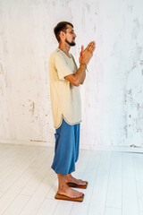 Practice of standing on nails. A man stands on a board with nails and makes namaste. Meditation on...