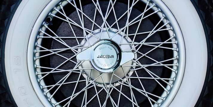 Antique Jaguar chrome spoke wheel with emblematic center nut detail