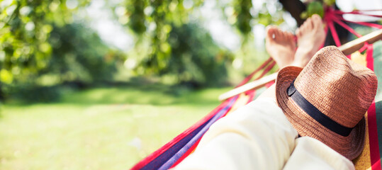 woman relax in hammock over summer garden background