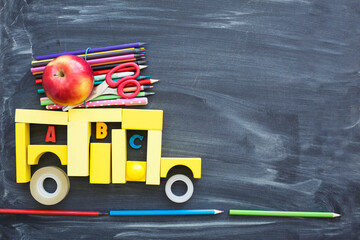 back to school background with black chalk board and school suppilents