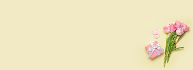 Fototapeta premium Gift for International Women's Day and bouquet of beautiful tulips on color background with space for text