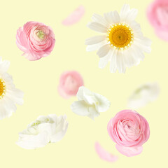 Flying fresh flowers on yellow background
