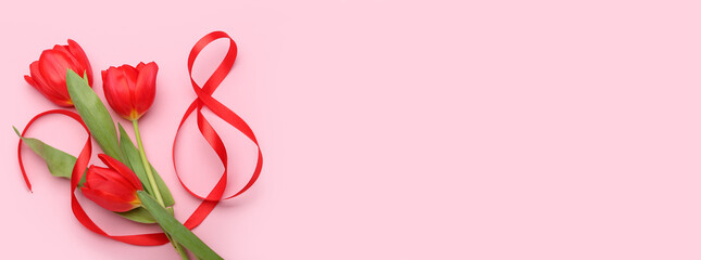 Figure 8 made of ribbon and tulip flowers for International Women's Day celebration on pink background with space for text