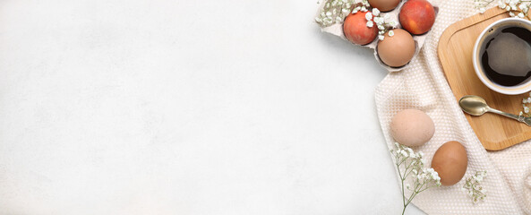 Composition with Easter eggs and cup of coffee on white background with space for text