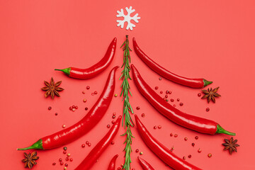 Christmas tree made of hot chili peppers and spices on red background
