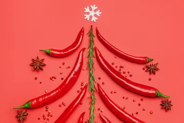 Fotobehang Chili Pepers Christmas tree made of hot chili peppers and spices on red background  © Pixel-Shot