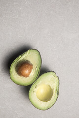 Avocado cut in half on kitchen table 