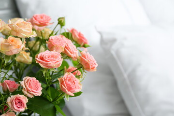 Bouquet of beautiful fresh roses in bedroom, closeup
