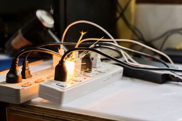 electric plug sparks Caused by short circuit The concept of danger, the use of non-standard...