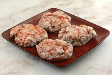 Glazed cherry fritters on red serving plate for breakfast or brunch