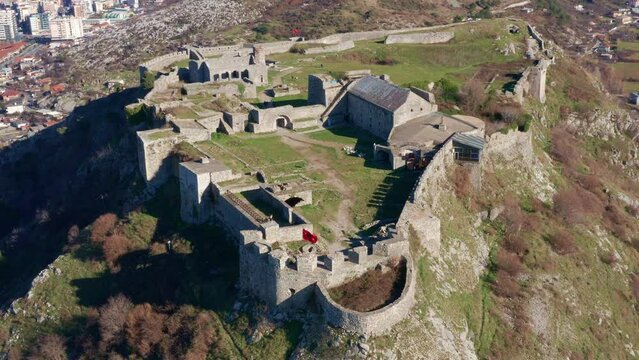 Rozafa or Shkoder castle is a hilltop archaeological park near Shkodra in Albania. Ancient fortress on top of a hill near the city of Skadar. Stone walls of medieval fortification - aerial drone view.