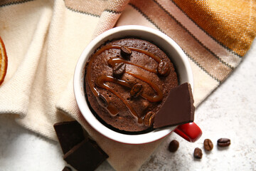 Cup with tasty chocolate brownie on table