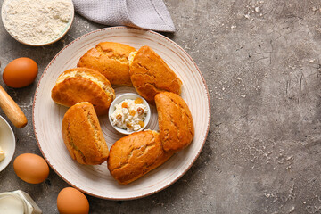Plate of tasty sochniki with cottage cheese on grey background