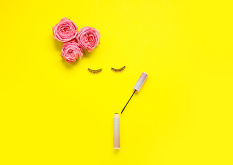 Creative composition with flowers, eyelashes and mascara for International Women's Day celebration on yellow background