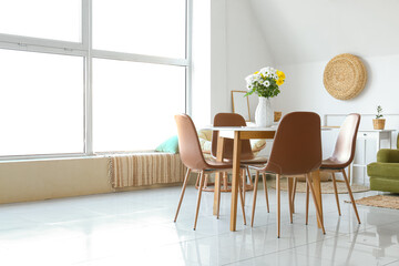 Vase with beautiful Chrysanthemum flowers on dining table in room