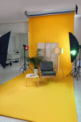 Stylish furniture in photo studio with professional equipment