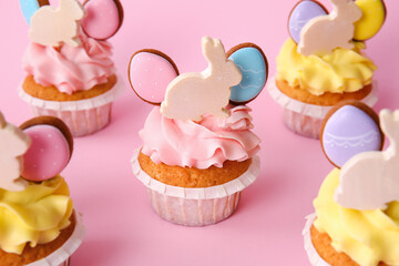 Tasty Easter cupcakes on pink background, closeup