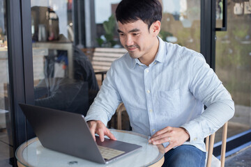 asian man work using computer hand typing laptop keyboard contact us.student study learning education online.adult professional people chatting search at office.concept for technology device business