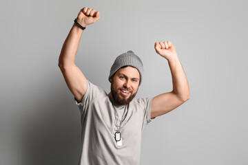 Fototapeta premium Stylish happy bearded man on grey background