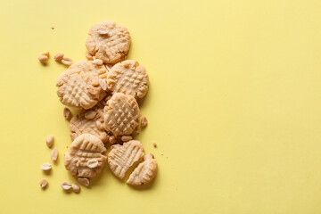 Tasty peanut cookies on yellow background