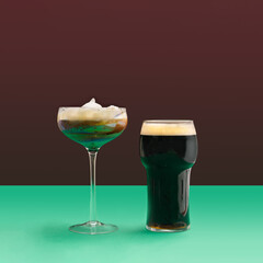 A modern glass Irish coffee with milk foam and pint of black stout beer glass and modern glass of . Minimal pub concept. Plum background.