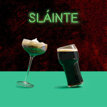 A unique Irish coffee glass and pint of black stout craft beer glass in front. Irish gaelic slainte  cheers in English green neon sign above.&nbsp;Dancing glasses modern concept. Plum concrete&nbsp;background.