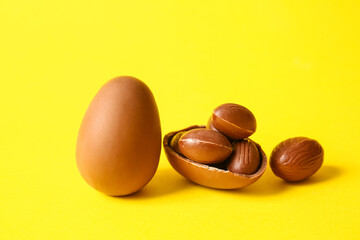 Chocolate Easter eggs on yellow background, closeup