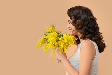 Beautiful young woman with mimosa flowers on color background - obrazy, fototapety, plakaty