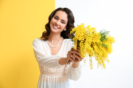 Beautiful Young Woman With Mimosa Flowers On Yellow And White Background