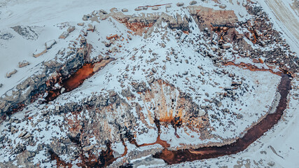 A rock quarry in winter covered in snow