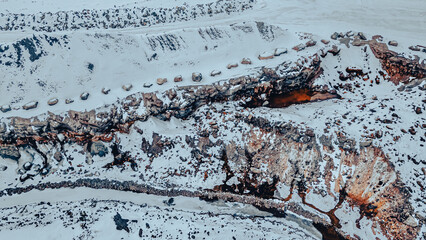 A rock quarry in winter covered in snow