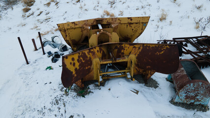 Long abandoned snow plow covered in snow