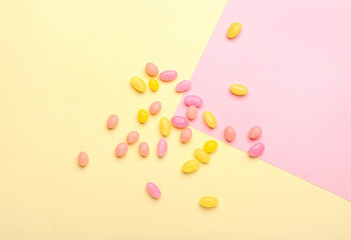 Different jelly beans on color background