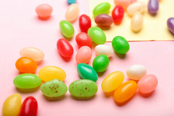 Different jelly beans on color background, closeup